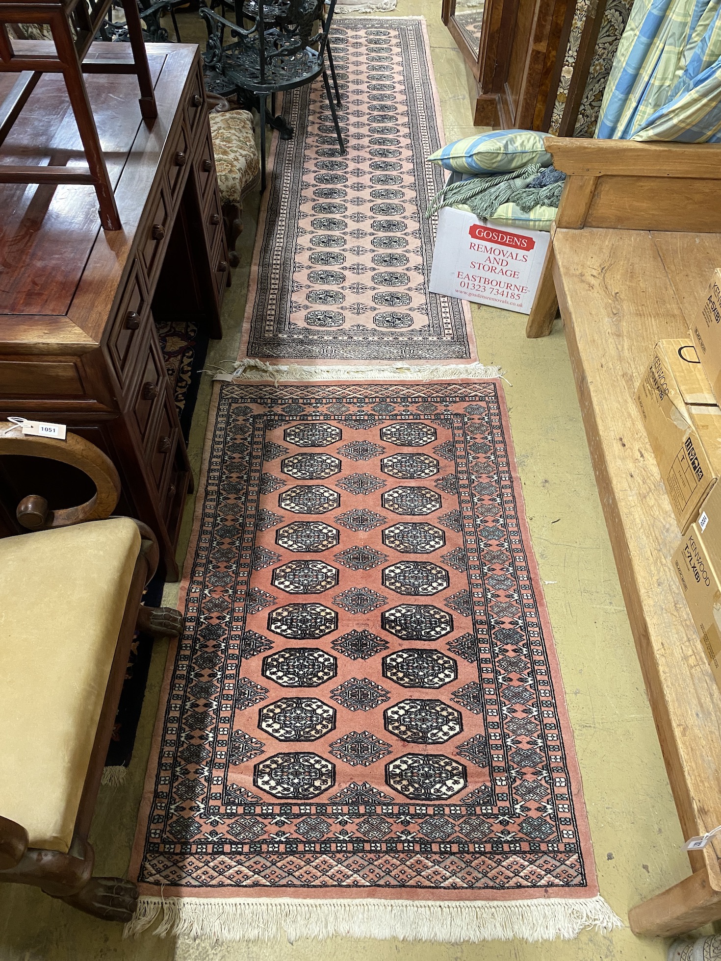 A Bokhara peach ground runner, 310 x 83cm together with a similar rug